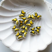 Perles en verre papillon 14x10 mm en verre - Jaune - Noir x1