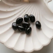 Perles nuggets irréguliers 13.5x9 mm en résine opaque - Noir pailleté doré x8