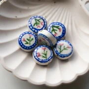 Perle ronde aplatie 19 mm en céramique - motif fleurs - Blanc - Bleu x1