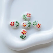 Perle ovale 19.5x14.5 mm en céramique - Motif fleur - Blanc - Rouge - Vert x1