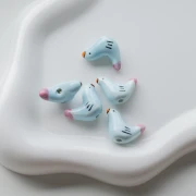 Perle oiseau 15x21 mm en céramique - Bleu ciel - Rose x1