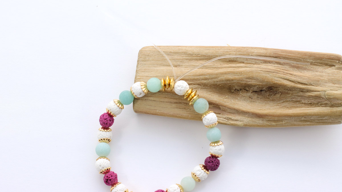 Tuto Bracelet élastique avec perles en pierre de lave fuchsia : Etape 2 Tuto Bracelet élastique avec perles en pierre de lave fuchsia : Etape 2