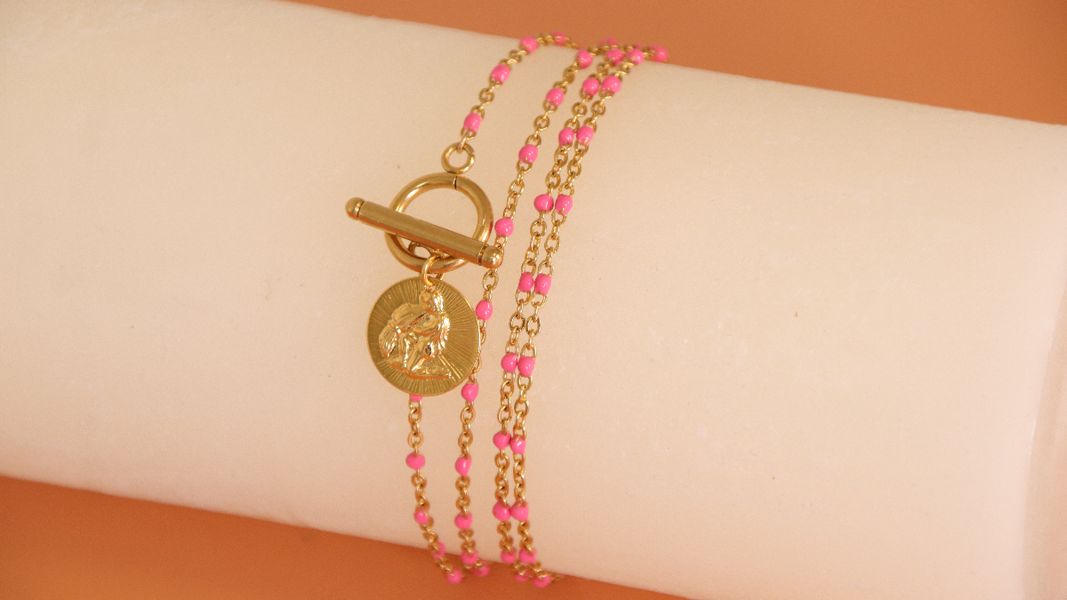 Schéma Collier acier inoxydable doré, perles résine fuchsia et breloque signe astro